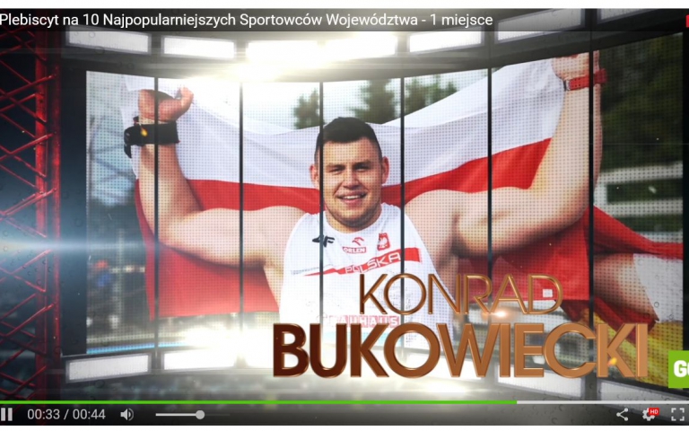 Konrad Bukowiecki na tle flagi Polski